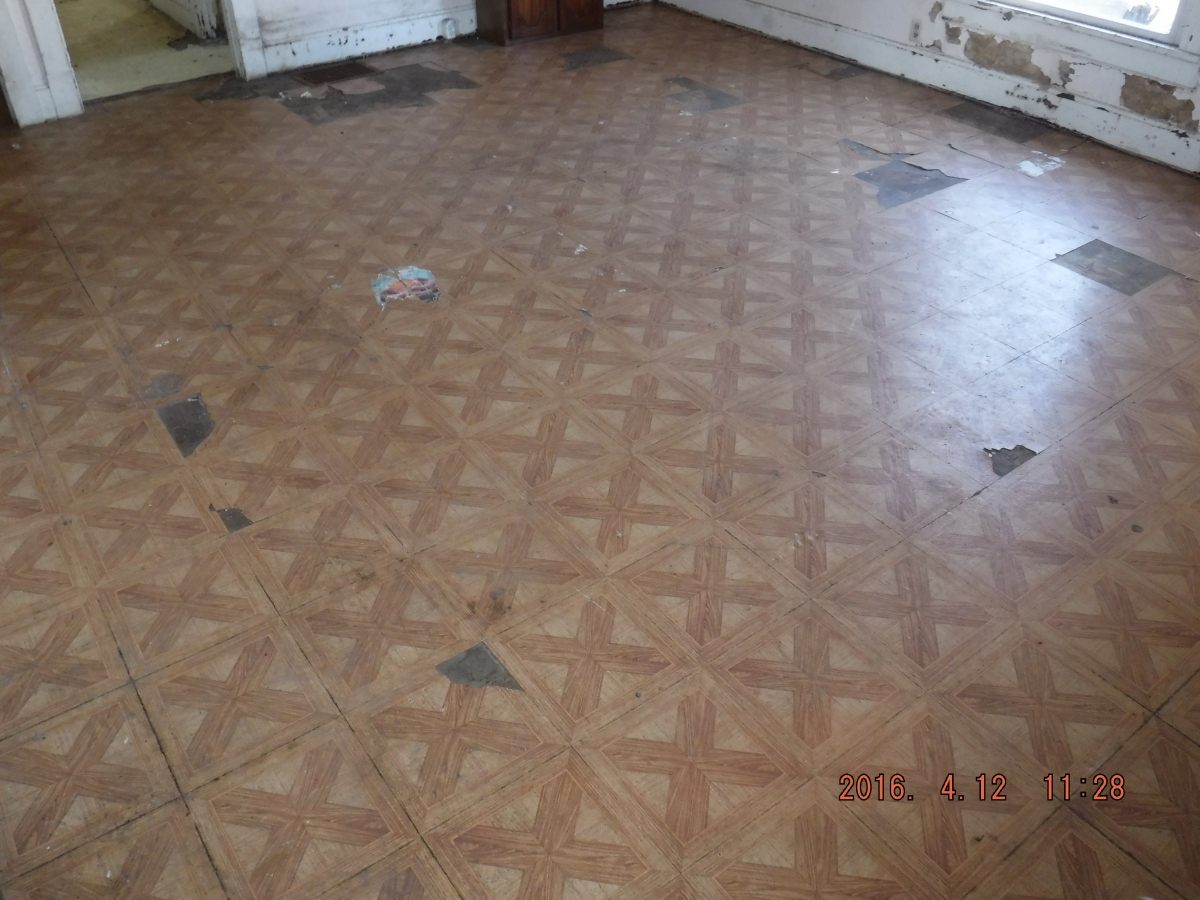 Damaged flooring before restoration