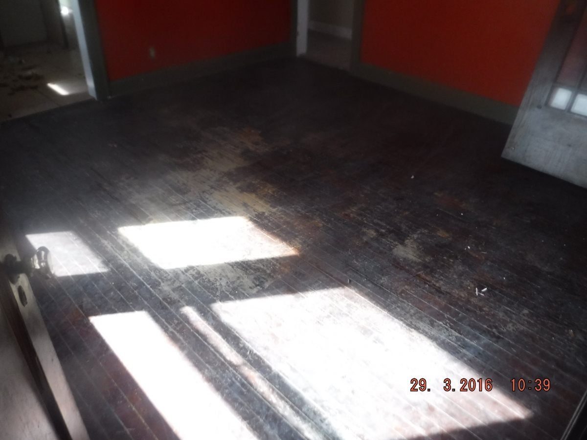 Damaged flooring before restoration